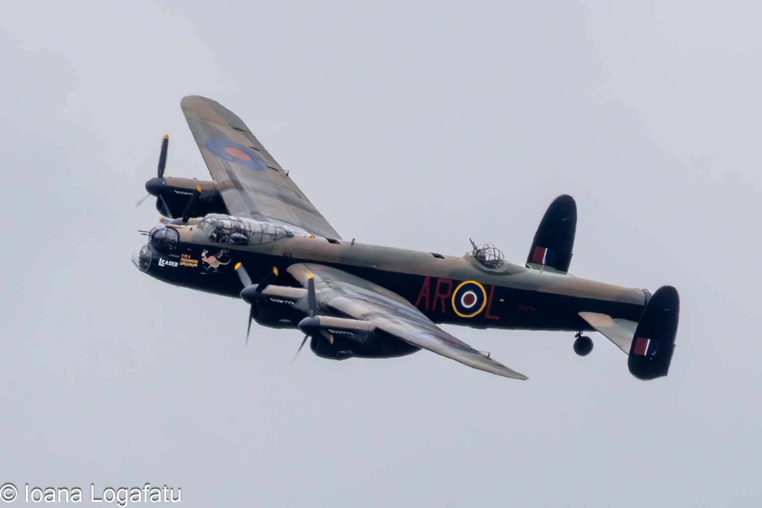 Historic aircraft soars through cloudy skies
